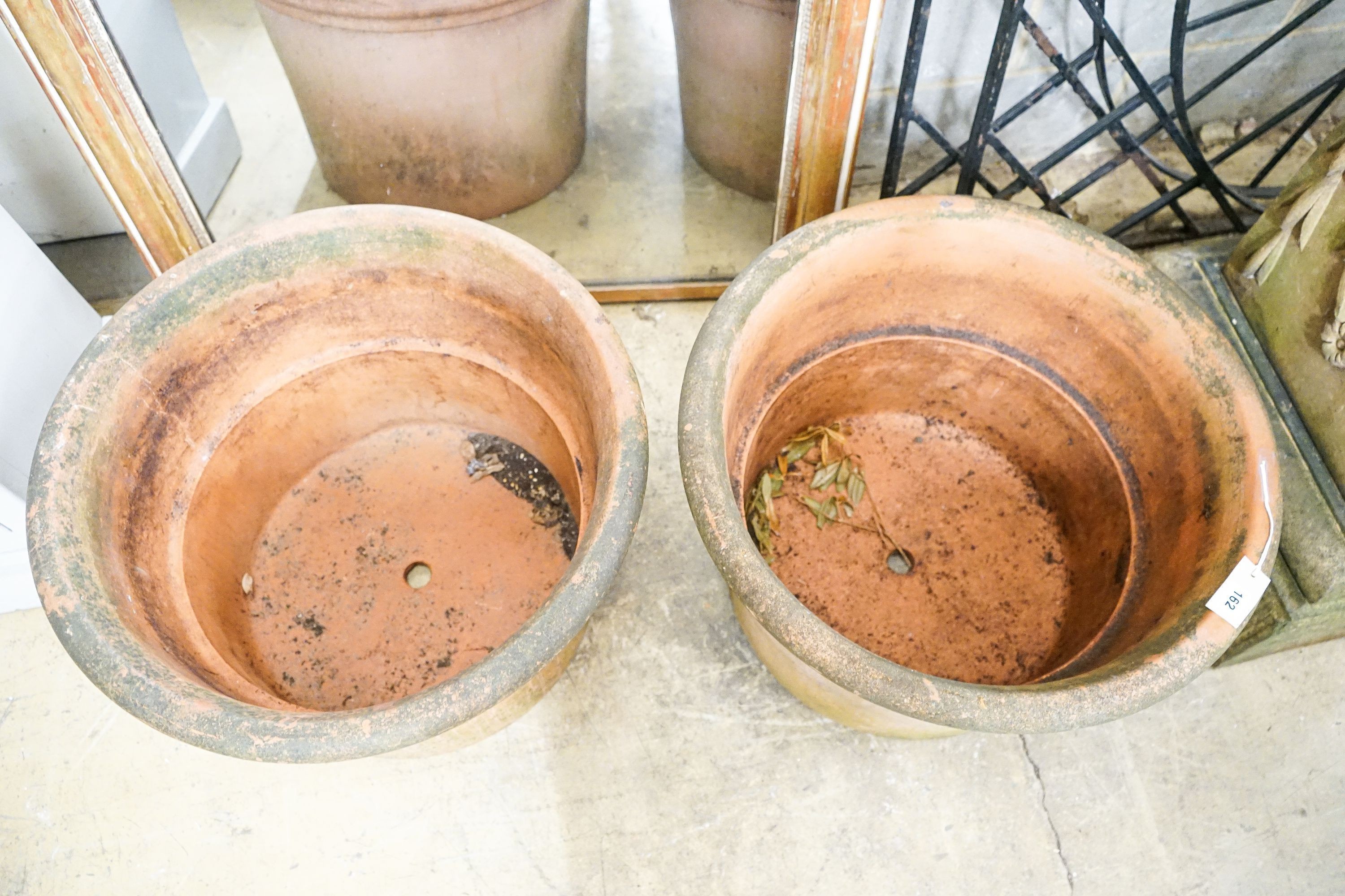 A near pair of large circular terracotta garden planters, diameter 64cm, height 45cm